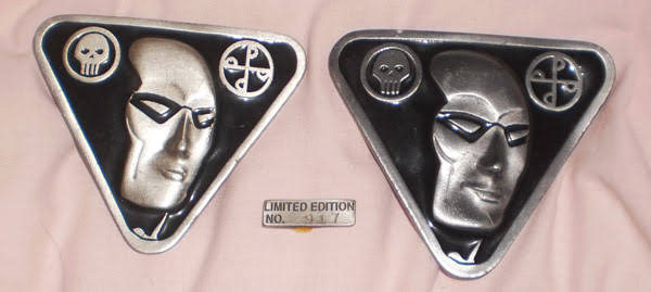 Two belt buckles showing the Phantom's face.